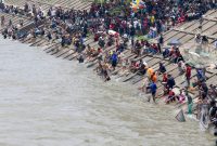 Ribuan Warga memadati bantaran Sungai Ciujung saat mengikuti tradisi Bedolan Pamarayan di Bendung Pamarayan Baru, Kabupaten Serang, Banten. (Dok/Total Banten)
